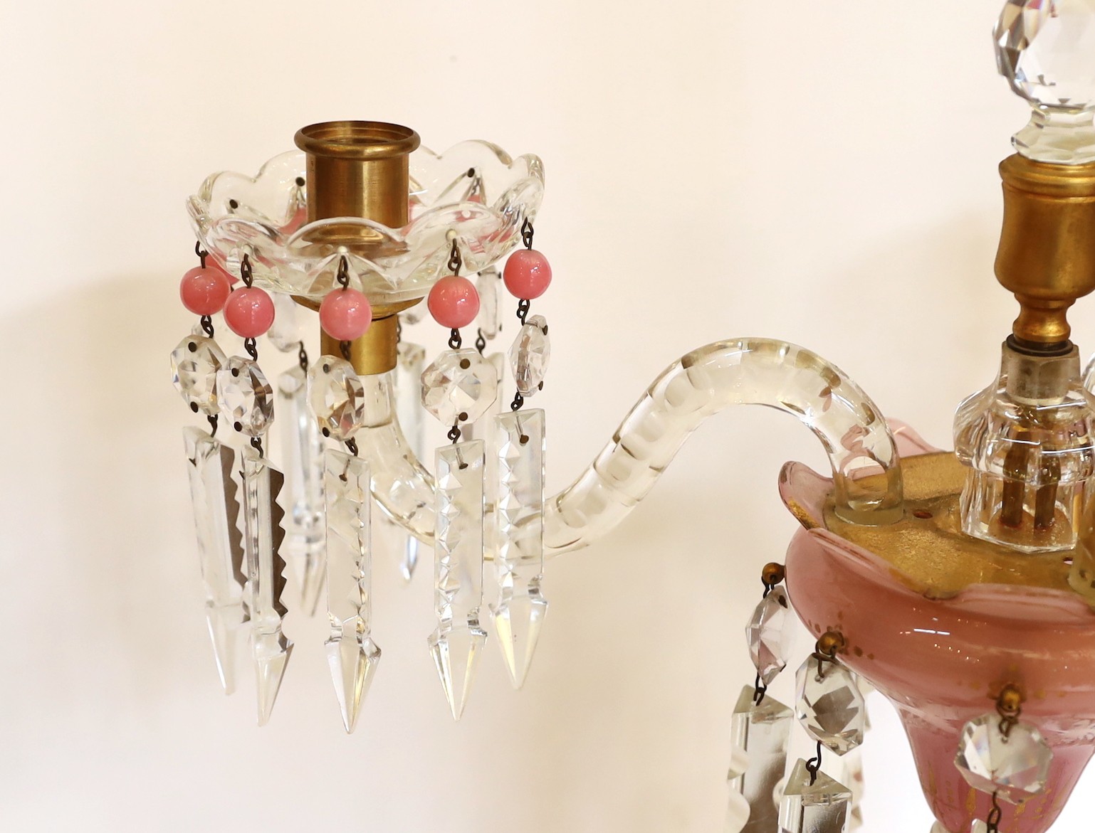 A pair of Victorian opaque pink and white glass lustre candelabra, with spear shaped finials and cut glass scrolling branches, height 52cm